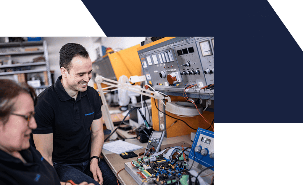 Zwei Mitarbeiter vor Elektronik-Prüfstation