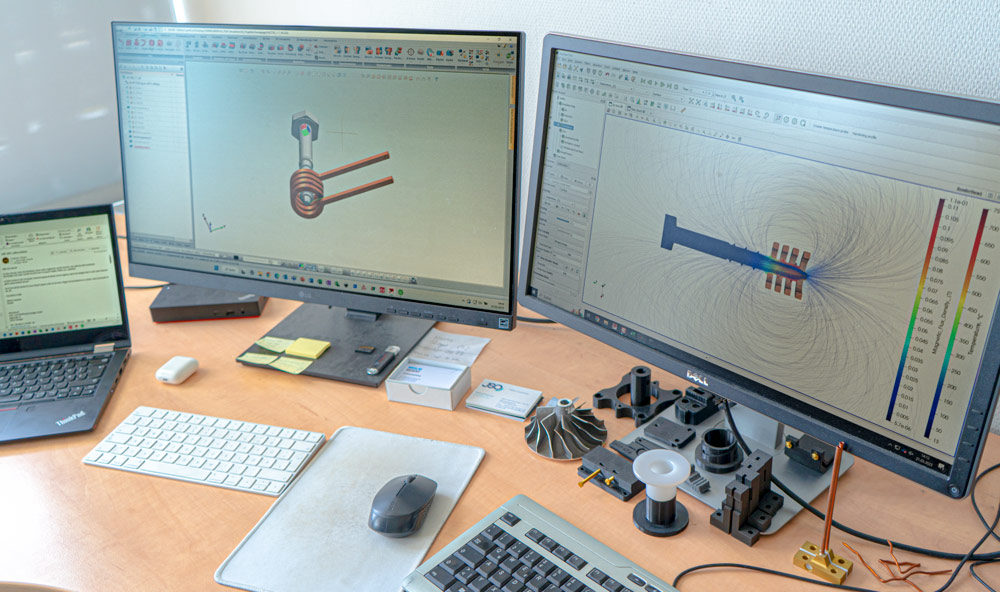 computerbildschirme auf denen eine induktion am werkstück simuliert wird